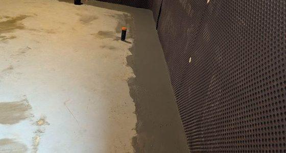 Finished interior waterproofing system around mechanical room
